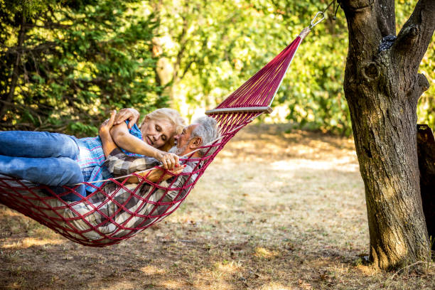 istock Senior Couple enjoying a romantic moment together in a hammock 1326087771