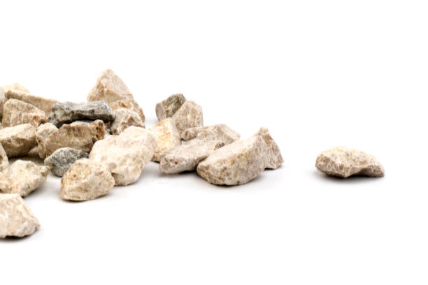 istock Gray small rocks ground texture isolated on white background. Small road stone. 1326089025