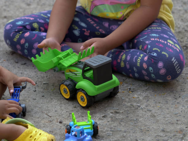 istock Close up of children's hands playing with car 1326089053