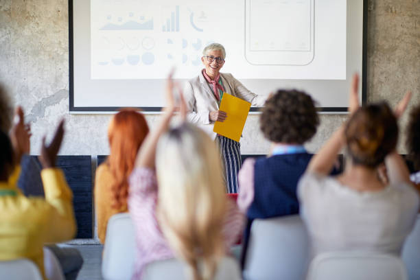 istock Group of young creative people in the office is clapping to a lecture held by their boss 1326089308