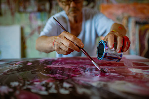 Creative and dedicated homeless person, in an abandoned messy, and dirty house, using his creativity to get away from his problems, enjoying every minute of painting