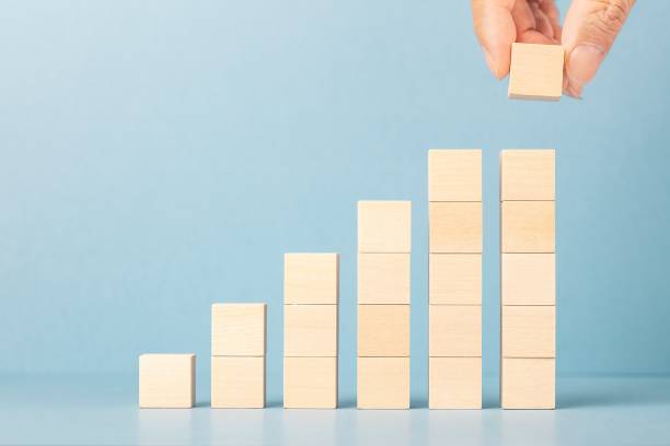 istock Toy wooden blocks without graphics as increasing graph bar, infographic diagram, chart over blue background. 1326089631