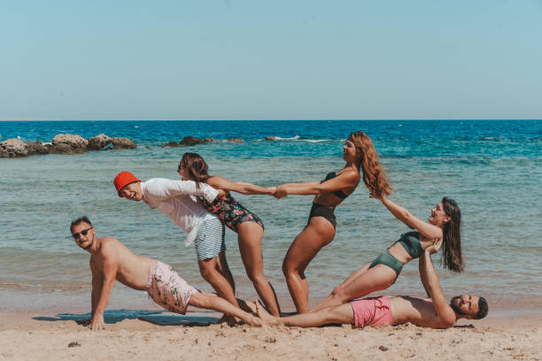 istock group of friends having fun at the beach. 1326090724