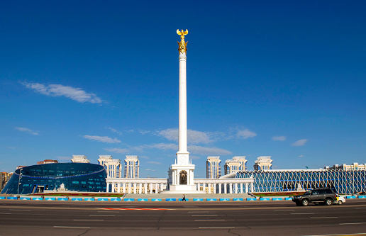 Nur-Sultan - Kazakhstan: June 10, 2021: Kazakh Eli Monument with Independence square, Kazakh National University of the Arts, Palace of Independence on Tauelsizdik avenue during a day