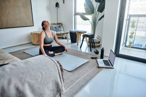 istock Shot of a young woman using a laptop while meditating at home 1326093219