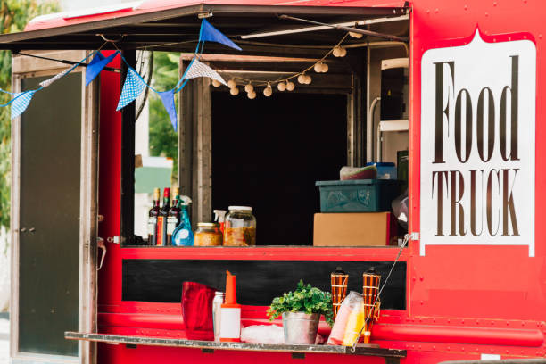 Window selling of a red food truck with pennants stock photo