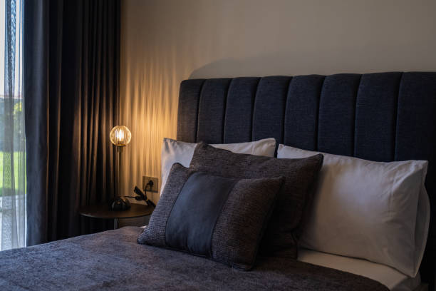 istock modern bedroom with bed by the window, dark colors 1326093411