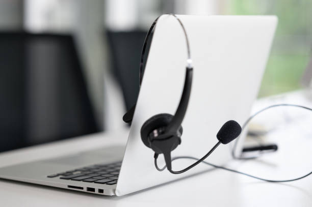 istock Headsets for call center teams are placed at a desk with a computer and laptop. while the team is in the break 1326096895