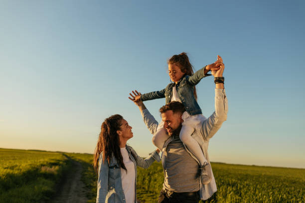 istock Happy family bonding together outdoors in the fields 1326097590