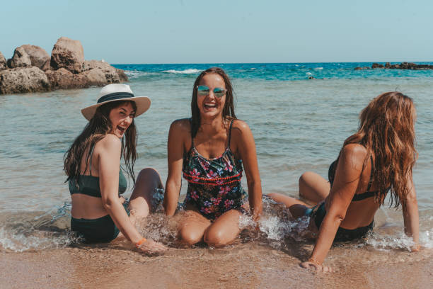 istock Group of beautiful young women have a rest on a beach. 1326098021