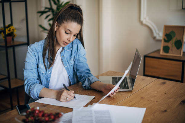 istock Woman paying bills at home 1326098107