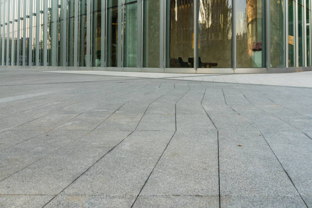 istock empty concrete ground floor with modern office buildings. 1326098981
