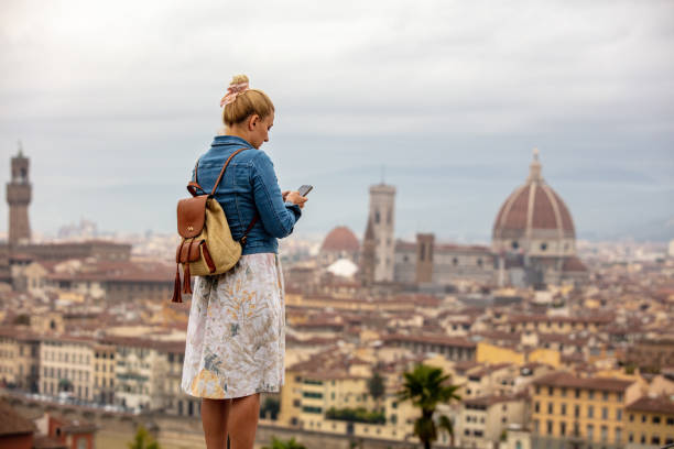 istock Young Woman In Florence City Using Cellphone 1326099183