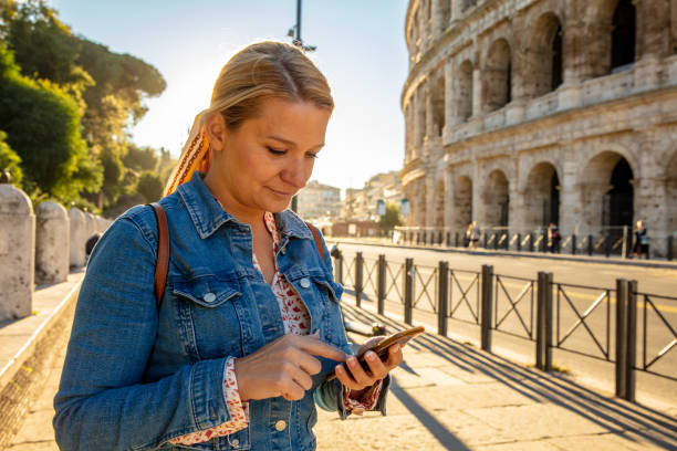 Woman Using The Smartphone At Colosseum In Rome,Italy Young Beautiful Woman Searching On Smartphone At Colosseum In Rome,Italy amalfi coast map stock pictures, royalty-free photos & images