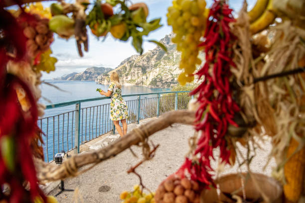 Woman Looking At Sea View Of A Woman Through Fruits And Vegetables Looking At Idyllic Sea amalfi food stock pictures, royalty-free photos & images