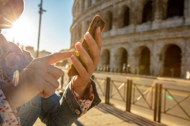 Woman Using The Cellphone At Colosseum In Rome,Italy Close-up Of Woman Using Smartphone At Colosseum In Rome,Italy amalfi coast map stock pictures, royalty-free photos & images