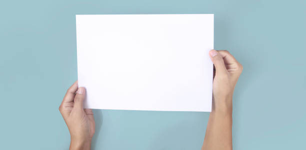 istock Hands holding paper blank for  letter paper 1326102134