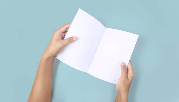 istock Hands holding paper blank for  letter paper 1326102146