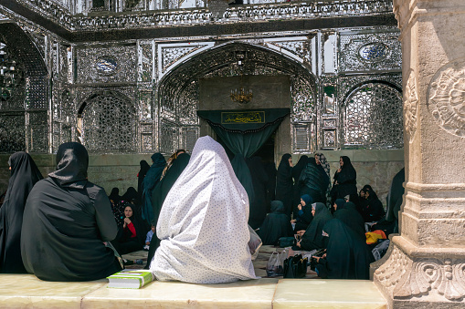 Qom, Iran - 04.20.2019: Islamic women in traditional dresses gathering before entrance to Fatima Masumeh Shrine. Hazrat Masumeh Holly Shrine