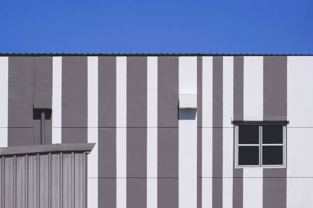 istock Glass window with air vent on modern white and grey building against blue sky 1326104680