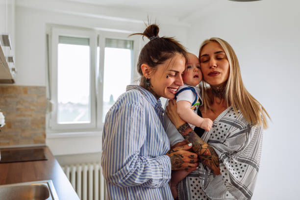 istock Cheerful young lesbians with baby boy 1326105269