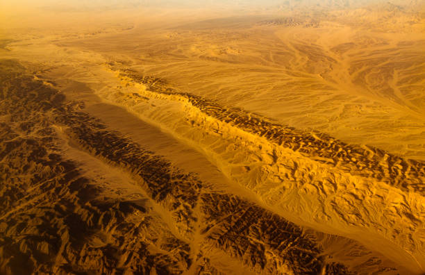 aerial panoramic view over asian desert sand dunes and canyons