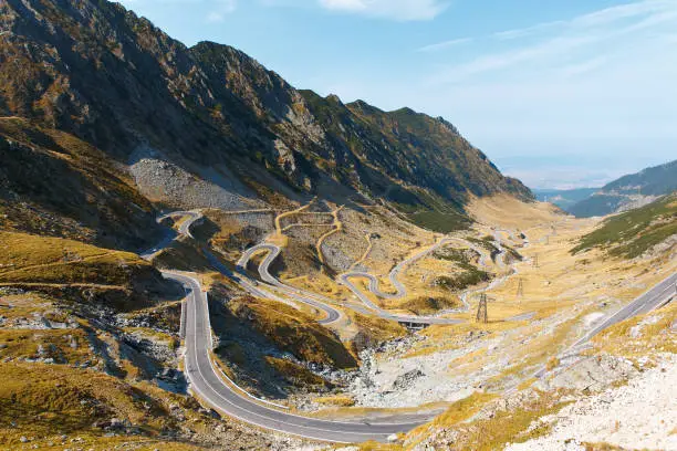 Transfagarash, winding road in Romania. Mountain road with serpentine with a beautiful view of the pass in sunny day.