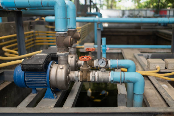 The water pump is located on the sewage well consisting of PVC pipe, brass check valve, ball valve, pressure gauge stock photo