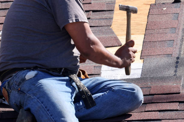 istock Man nailing shingles on roof with roofing hammer 1326109380