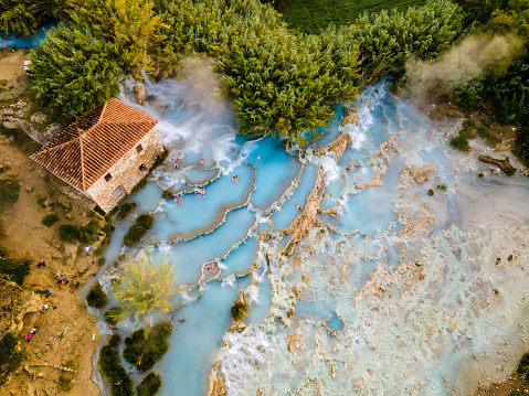 Aerial View Of People Enjoying At Thermal Waterfalls And Travertine Pool