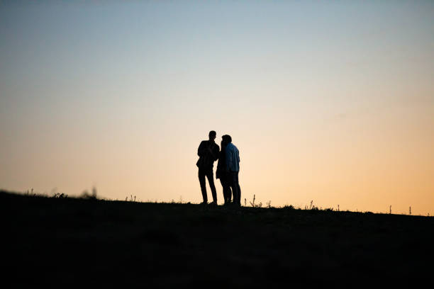 Silhouette Of People Standing On Agricultural Field In Italy,Tuscany