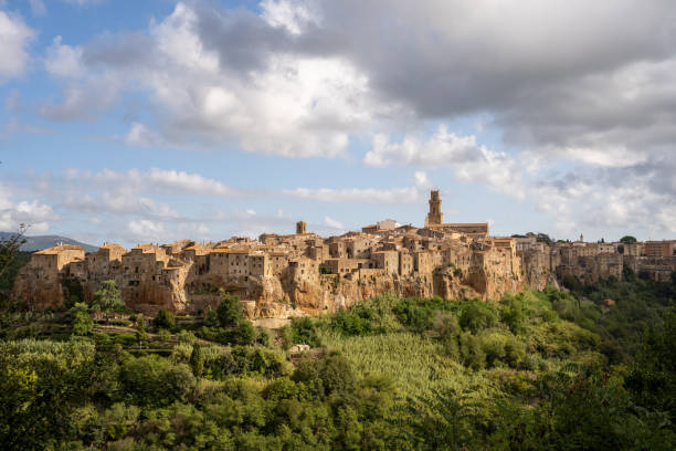 Photo of an old village located on a hill, Pitigliano, Italy Panoramic view of a medieval village situated on a hill pitigliano stock pictures, royalty-free photos & images