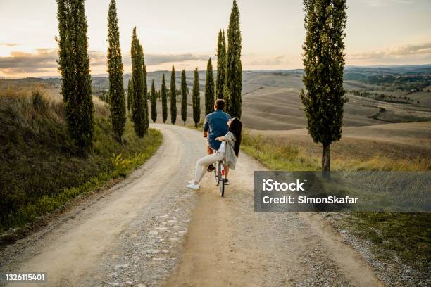 Couple Riding On The Bicycle Stock Photo - Download Image Now - Couple - Relationship, Tuscany, Italy