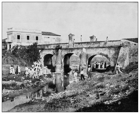 Antique black and white photograph of people from islands in the Caribbean and in the Pacific Ocean; Cuba, Hawaii, Philippines and others: Bridge on Belasco creek, Santa Clara, Cuba