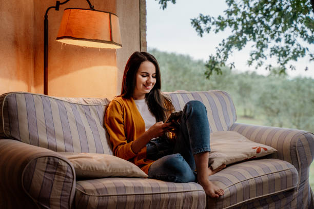 istock Girl sitting on the couch 1326115864