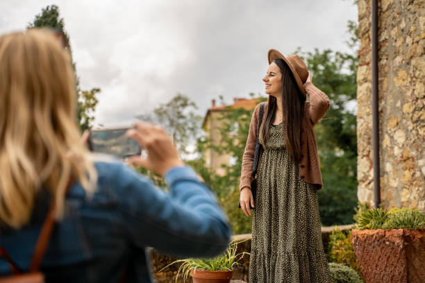 istock Female tourist taking photos with smart phone while on holiday 1326116882