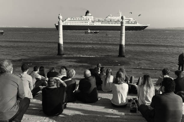 Lisbon, Portugal - April 12, 2014: People relax by the Tagus River in Lisbon downtown.
