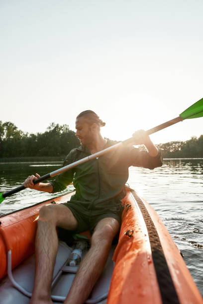 istock Active caucasian young man kayaking in a lake on a summer day 1326120360