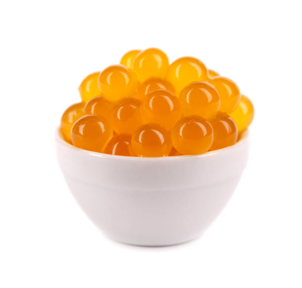 istock Red tapioca pearls for bubble tea isolated on white background. Tapioca pearls in white ceramic spoon. 1326120567