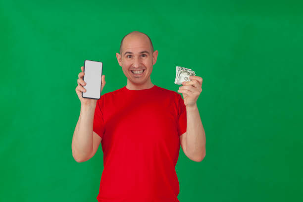 istock A man holding money and a smartphone 1326121620