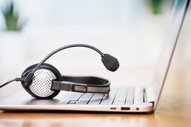istock Laptop with headphones or headset on white desk 1326121773