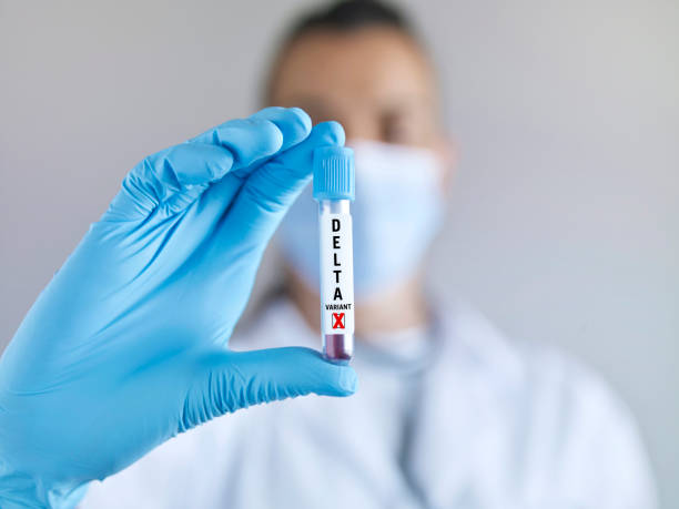 Delta variant Doctor holding a blood sample with Covid-19 Delta variant b117 covid 19 variant stock pictures, royalty-free photos & images