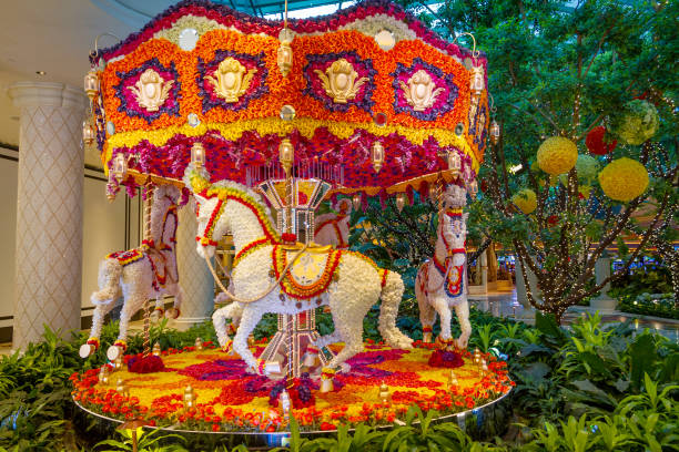 Flower carousel at Wynn Las Vegas Las Vegas, NV, USA – June 8, 2021: Flower carousel with three horses in the Wynn Hotel and Casino located in Las Vegas, Nevada. wynn las vegas stock pictures, royalty-free photos & images