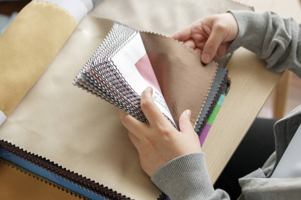 istock female designer with fabric color samples choosing textile for curtains 1326129957