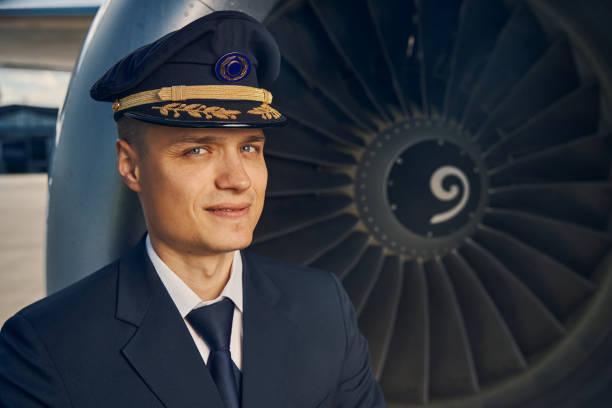 istock Good-looking male pilot standing by an aeroengine 1326132143
