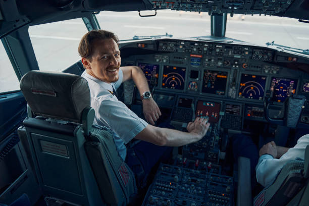 istock Joyful chief pilot posing for the camera in the cockpit 1326132262