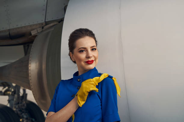 istock Serene flight attendant standing by a landed airliner 1326132334
