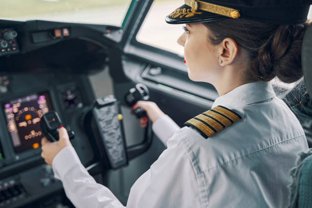 istock Serious concentrated female aviator piloting an aircraft 1326132422