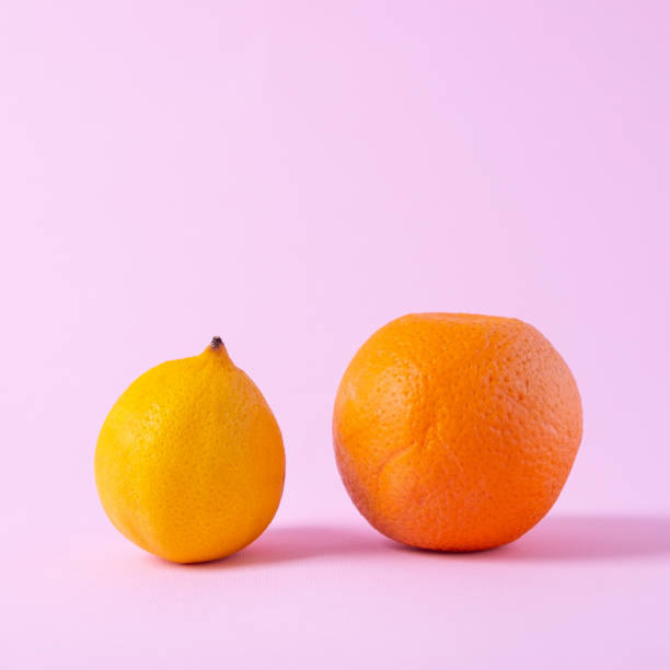 istock close-up orange and lemon minimalism on a pink background 1326134695