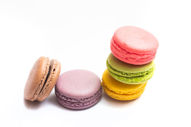 istock Various flavors of pastel macarons stacked against isolated on white background. 1326137030